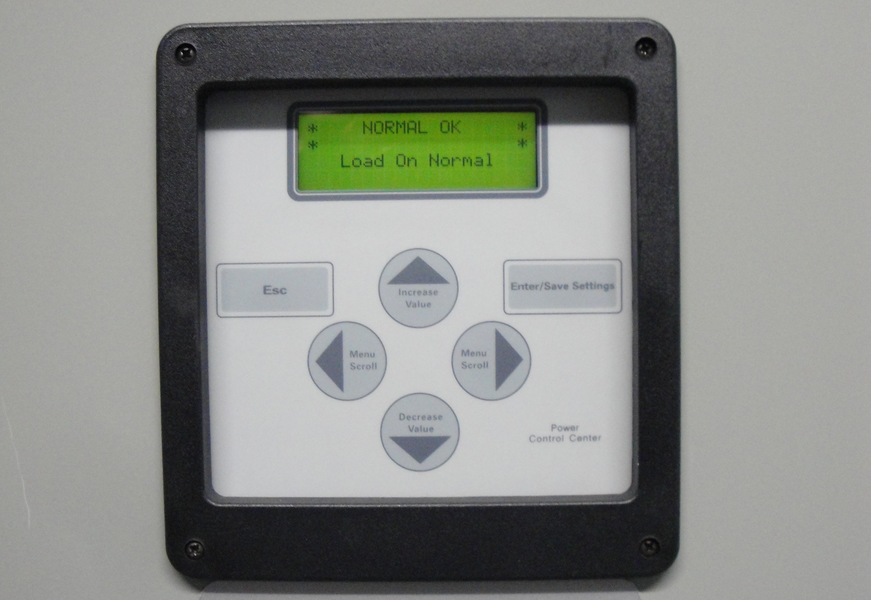 White Power Control Panel with Lit LED Screen, Button Settings, and Black Border, Affixed to the Facility Wall